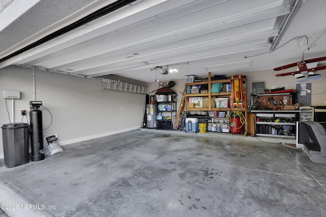 garage with water heater and a workshop area