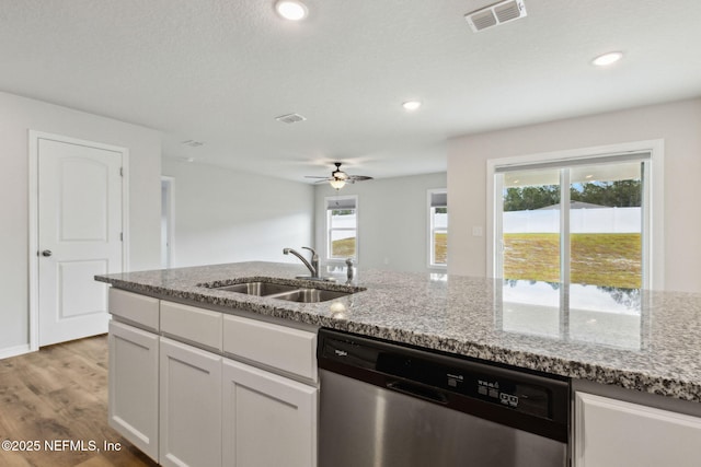 195 River Rdg Pl, Welaka, FL 32193 - kitchen with light stone countertops, sink, stainless steel dishwasher, and white cabinets
