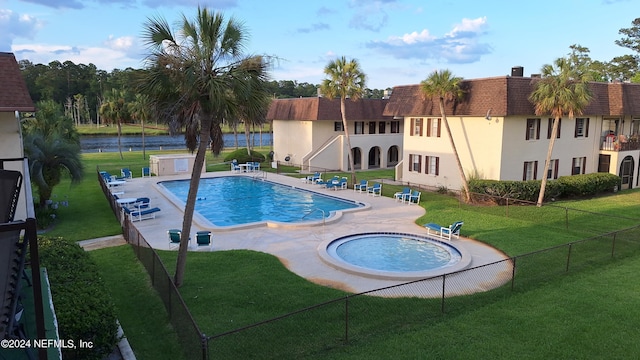 view of swimming pool featuring a lawn and a patio area