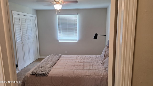 carpeted bedroom featuring ceiling fan and a closet