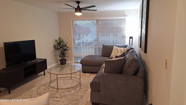 living room featuring ceiling fan and light wood-type flooring