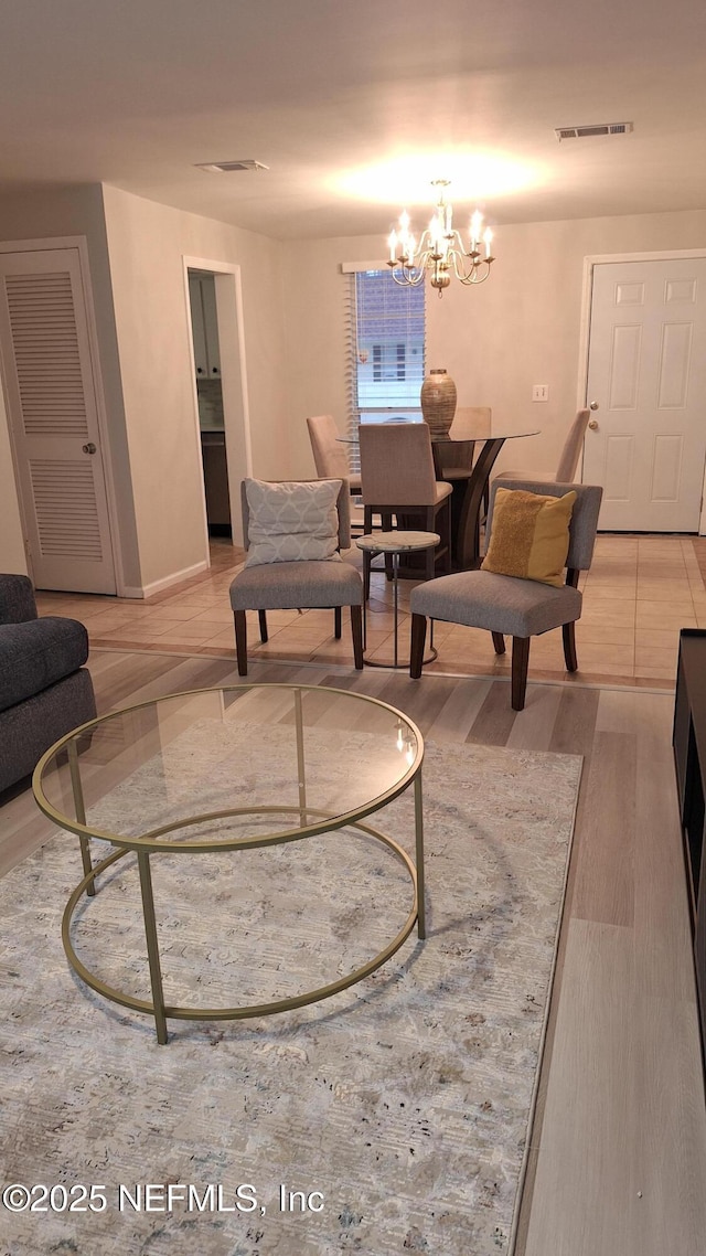 living room featuring a chandelier and hardwood / wood-style floors