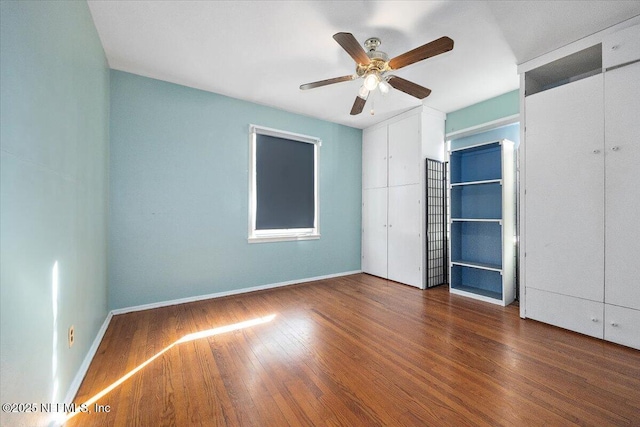 unfurnished bedroom featuring dark wood-type flooring and ceiling fan