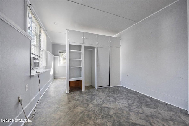 unfurnished bedroom featuring a closet and cooling unit