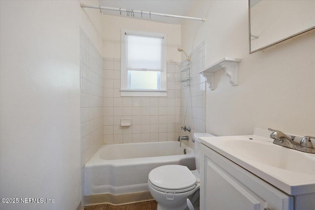 full bathroom with toilet, vanity, tiled shower / bath, and tile patterned flooring