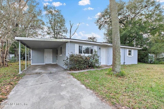 view of front of property with a front yard and a carport