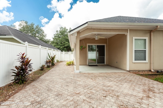 back of house with ceiling fan and a patio area