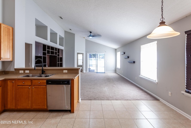 kitchen featuring decorative light fixtures, ceiling fan, stainless steel dishwasher, sink, and light tile patterned floors