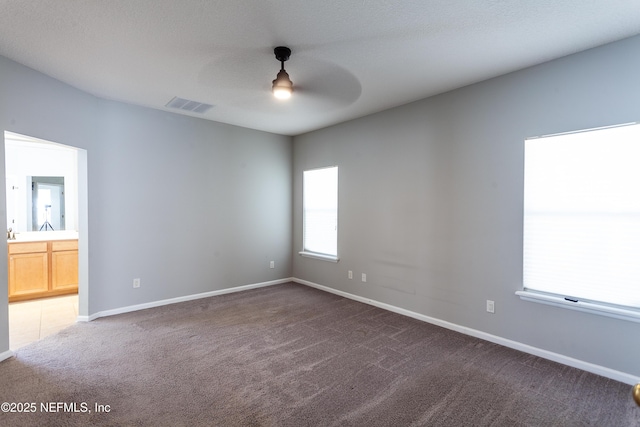 carpeted empty room with ceiling fan