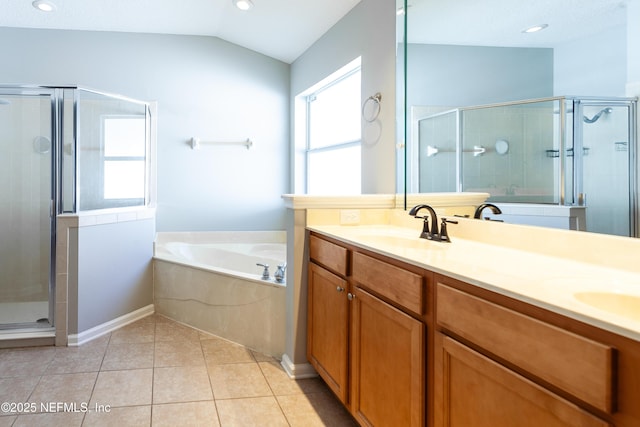 bathroom with vanity, tile patterned flooring, vaulted ceiling, and independent shower and bath