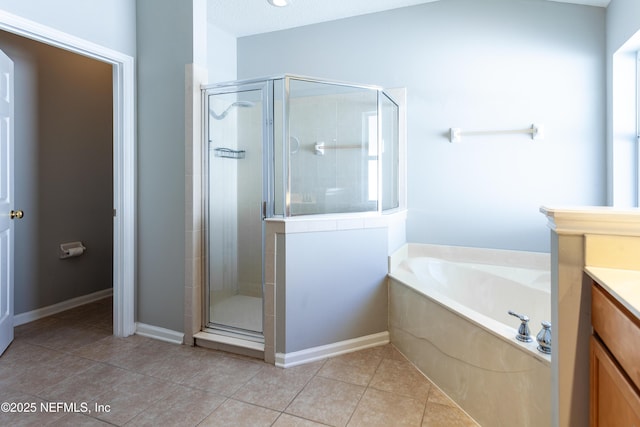 bathroom with vanity, tile patterned floors, and shower with separate bathtub