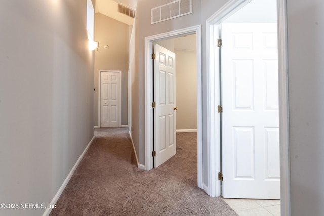 hallway featuring light colored carpet