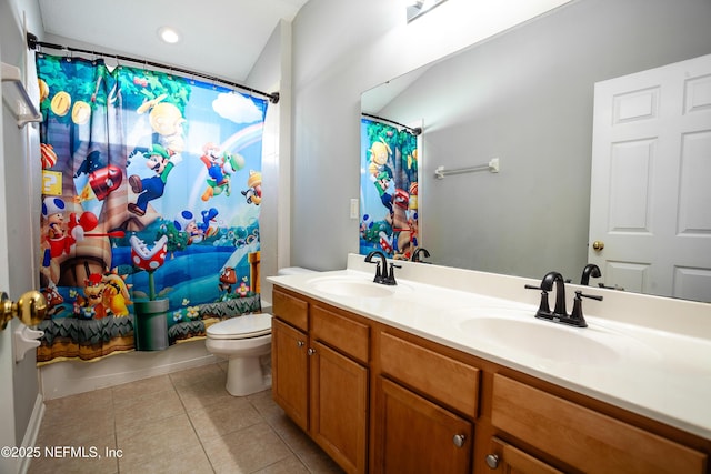 bathroom featuring curtained shower, tile patterned floors, vanity, and toilet