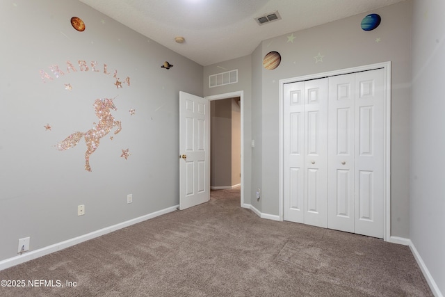 unfurnished bedroom with carpet floors and a closet