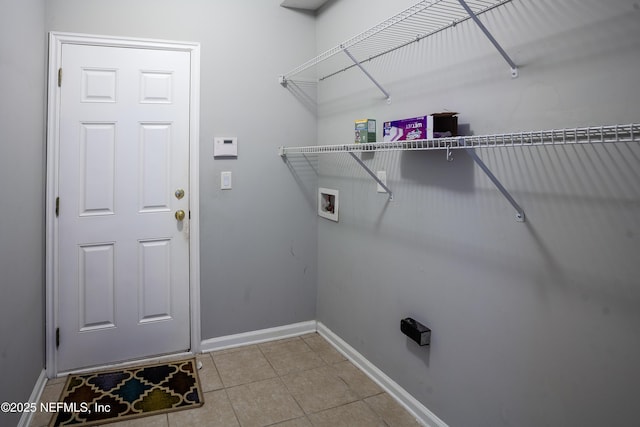 laundry room with light tile patterned floors and hookup for a washing machine