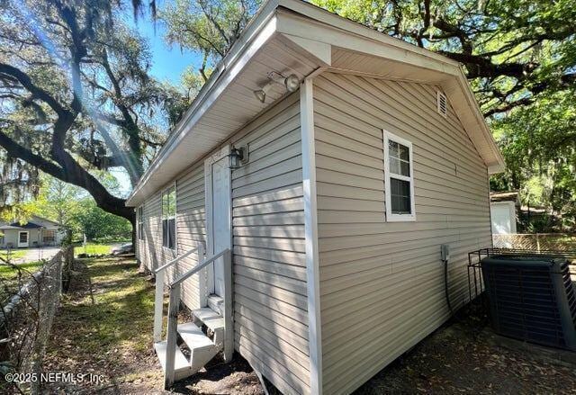 view of side of home featuring central air condition unit