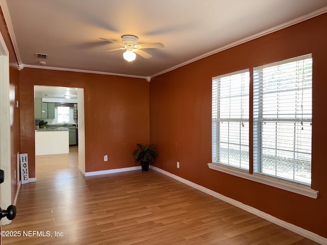361 Broward St, Jacksonville, FL 32204 - unfurnished room featuring light wood-style flooring, ceiling fan, baseboards, visible vents, and crown molding