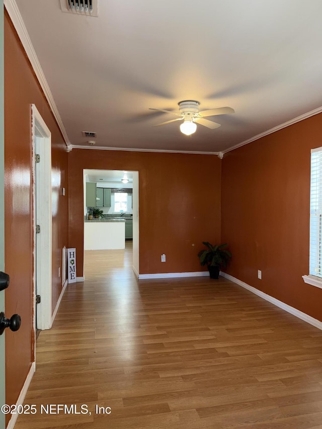 361 Broward St, Jacksonville, FL 32204 - spare room featuring ceiling fan, light wood-type flooring, ornamental molding, and baseboards