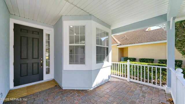 view of exterior entry with covered porch