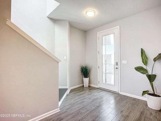 entryway featuring a textured ceiling and hardwood / wood-style floors