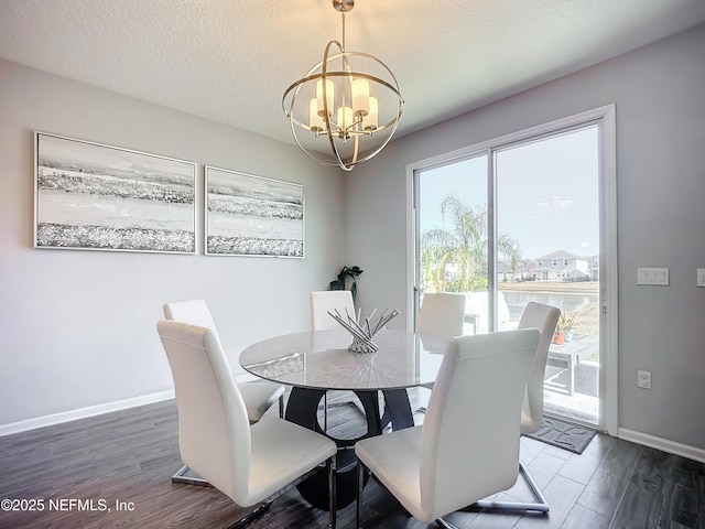 dining space with dark wood-type flooring, an inviting chandelier, and a textured ceiling