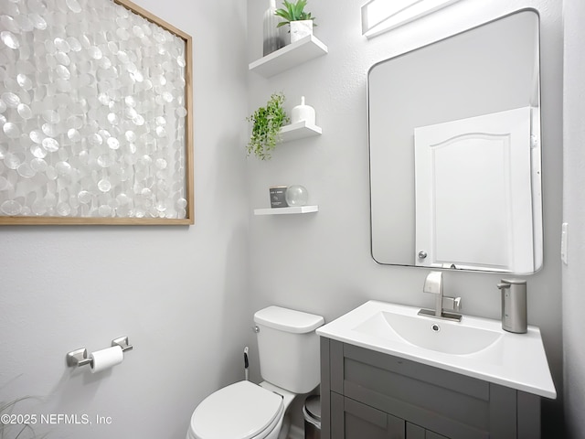 bathroom with toilet and vanity