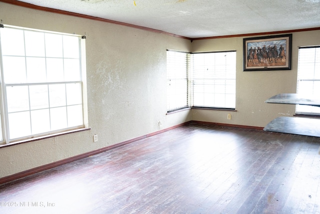 unfurnished room with wood-type flooring, ornamental molding, and a textured ceiling