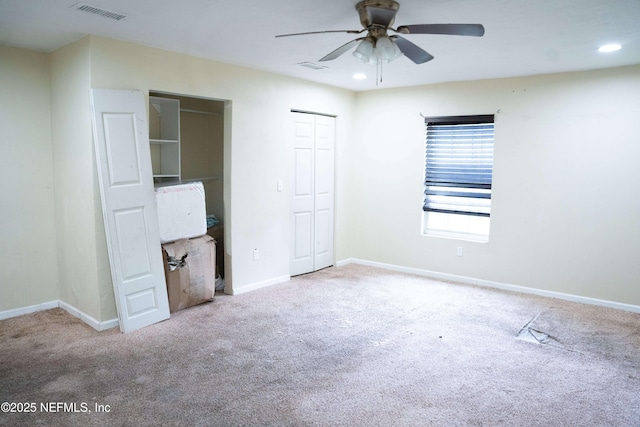 unfurnished bedroom featuring ceiling fan and light colored carpet