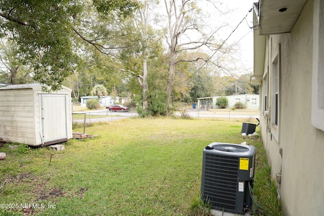 view of yard with cooling unit and a storage shed