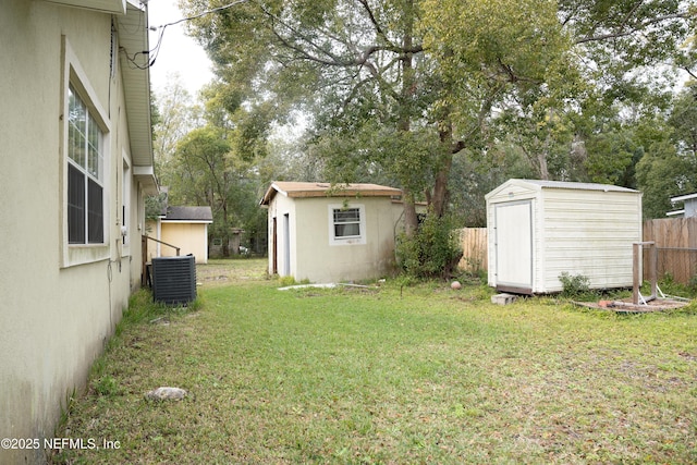 view of yard with a storage shed and central AC unit