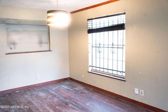 unfurnished room with dark hardwood / wood-style flooring and ornamental molding