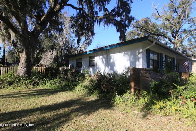 view of side of home featuring a yard