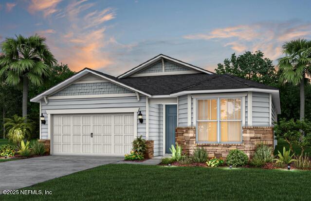 view of front of property with a garage and a lawn