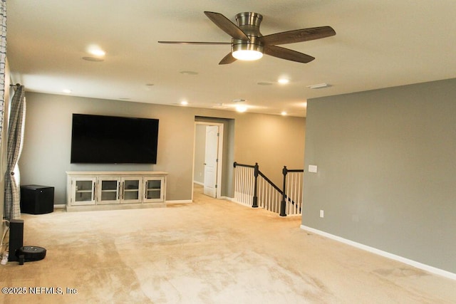 unfurnished living room with light carpet and ceiling fan