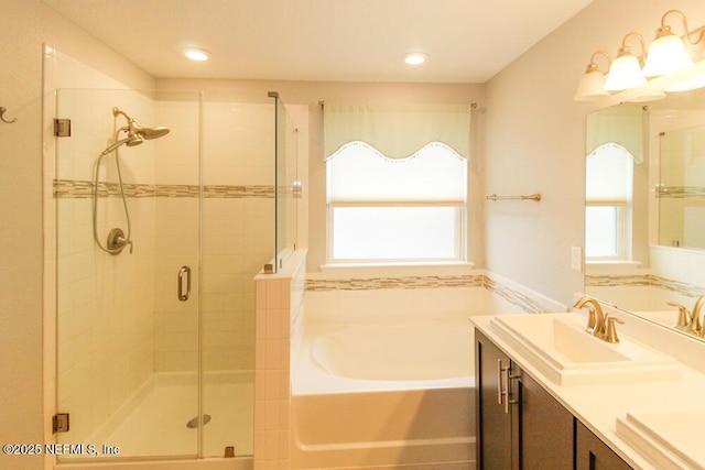 bathroom featuring vanity and separate shower and tub