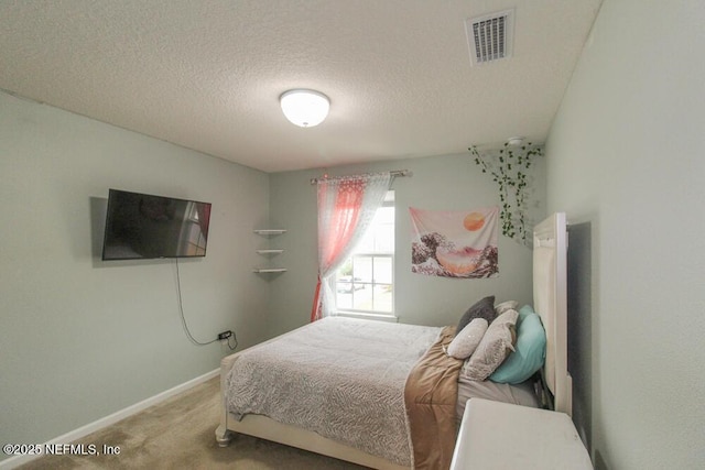 bedroom with carpet floors and a textured ceiling