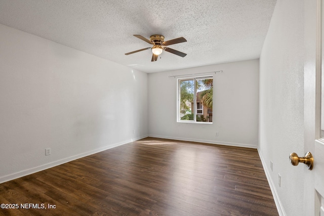 empty room with ceiling fan, dark wood-type flooring, and a textured ceiling