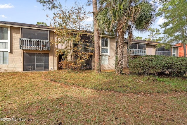 rear view of property featuring a yard