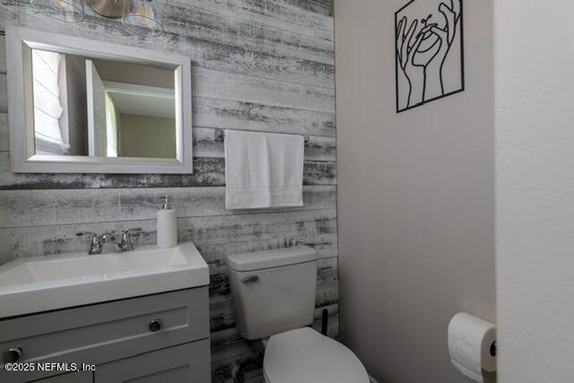 bathroom featuring toilet and vanity