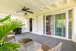 view of patio featuring ceiling fan