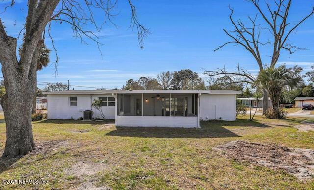 back of house featuring central AC, a yard, and a sunroom