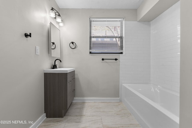 bathroom featuring a washtub and vanity