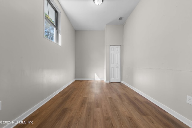 empty room with dark hardwood / wood-style flooring