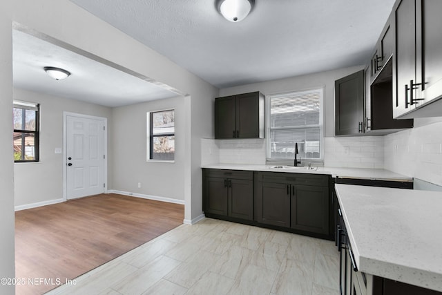 kitchen featuring tasteful backsplash, sink, and a textured ceiling