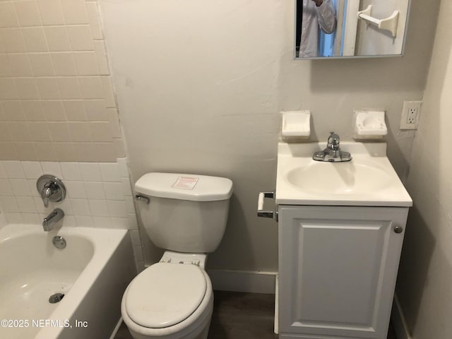 full bathroom with tiled shower / bath combo, vanity, and toilet