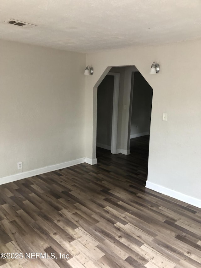 spare room with dark hardwood / wood-style floors