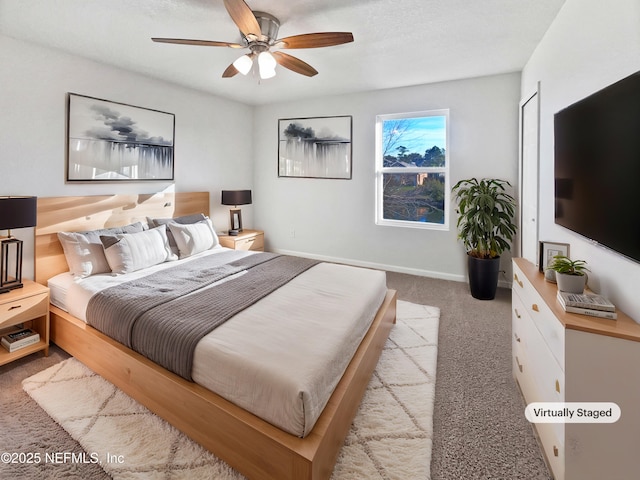 bedroom featuring ceiling fan and light carpet