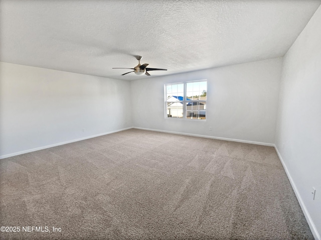 spare room featuring a textured ceiling, ceiling fan, and carpet flooring