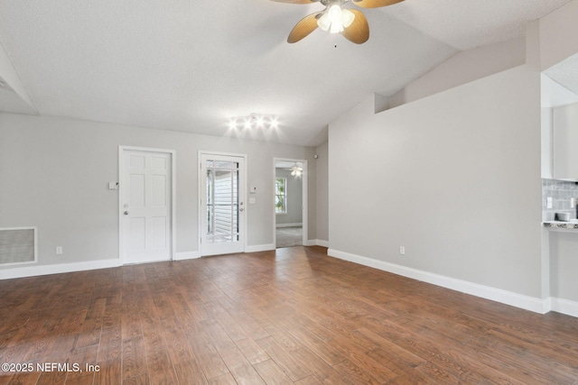 unfurnished room with lofted ceiling, hardwood / wood-style flooring, a textured ceiling, and ceiling fan