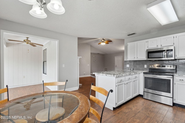 kitchen featuring white cabinetry, backsplash, stainless steel appliances, and kitchen peninsula